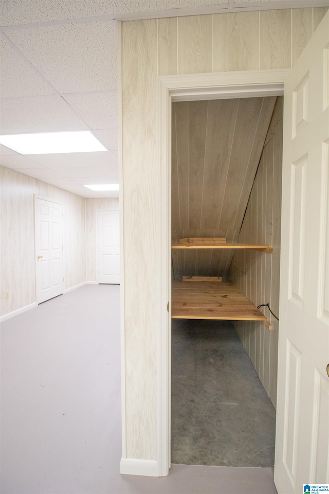 view of sauna with concrete flooring and wooden walls