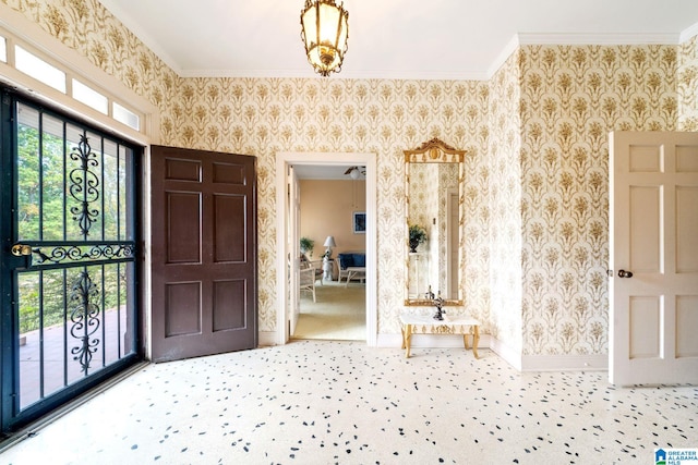 carpeted foyer with crown molding