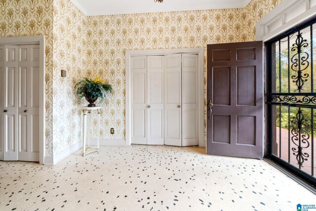 carpeted entryway with crown molding