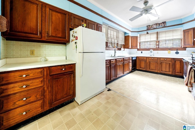 kitchen with ceiling fan, white fridge, backsplash, and ornamental molding