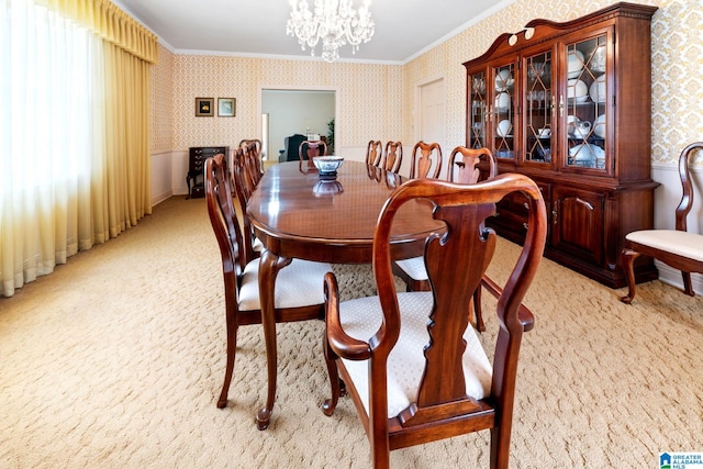 carpeted dining space with ornamental molding, a notable chandelier, and a healthy amount of sunlight