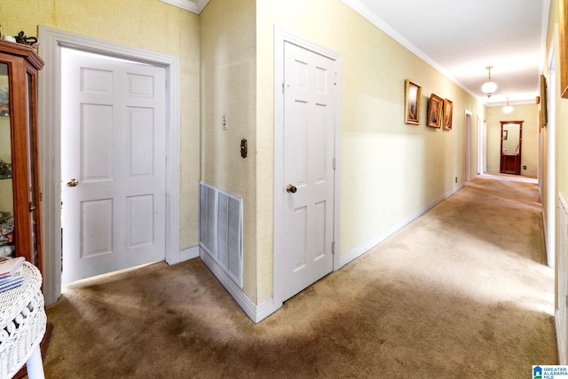 hall featuring carpet floors and crown molding