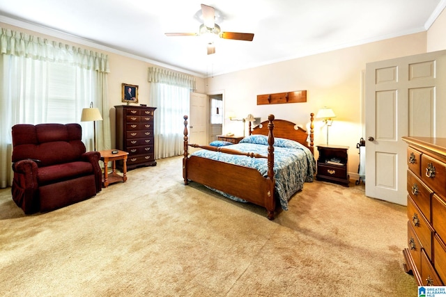 bedroom featuring ornamental molding, light colored carpet, and ceiling fan