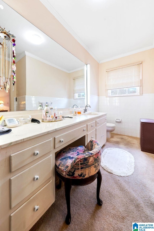 bathroom featuring toilet, vanity, tile walls, and crown molding