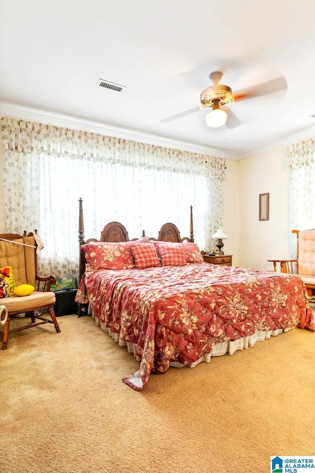 bedroom with ceiling fan, carpet flooring, and ornamental molding