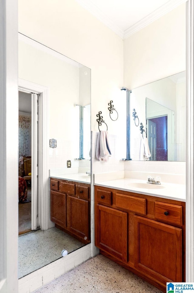 bathroom featuring ornamental molding and vanity