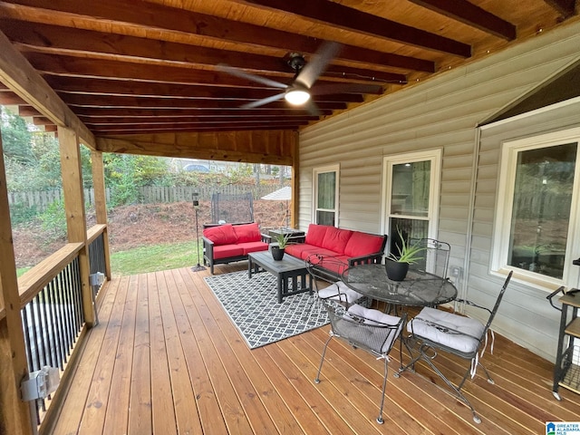 wooden terrace with an outdoor living space and ceiling fan