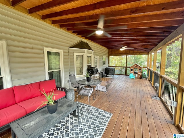 wooden terrace with area for grilling, ceiling fan, and an outdoor hangout area