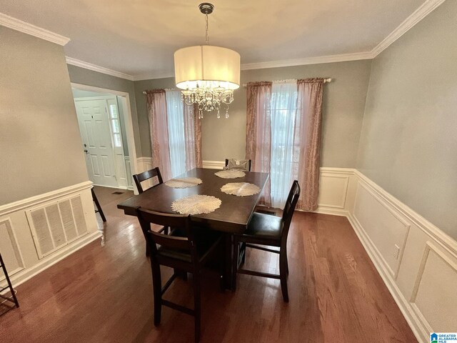 dining space with a chandelier, dark hardwood / wood-style flooring, and ornamental molding