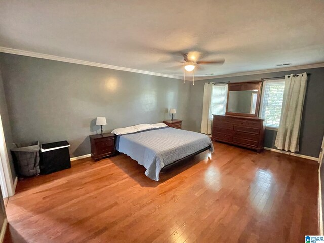 bedroom featuring ornamental molding, hardwood / wood-style floors, and ceiling fan