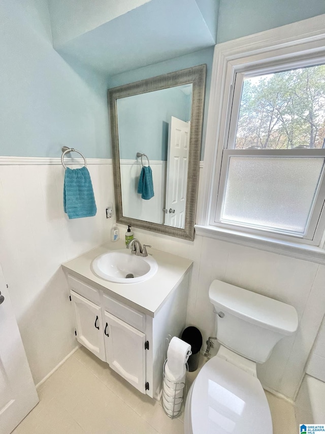 bathroom featuring vanity, tile patterned floors, and toilet