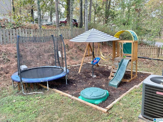 view of play area with central air condition unit and a trampoline