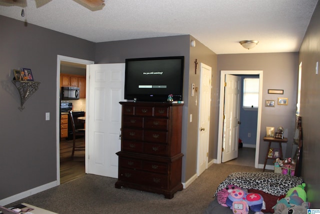 bedroom with a textured ceiling, ceiling fan, and carpet flooring