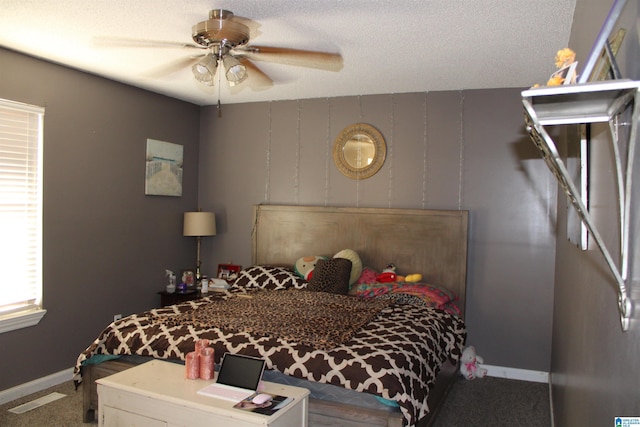 bedroom featuring carpet floors, ceiling fan, and a textured ceiling