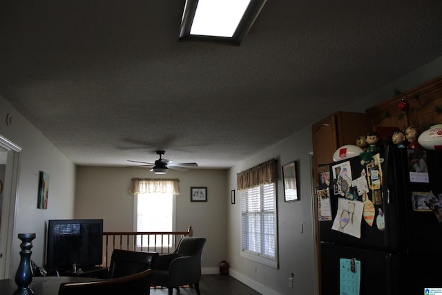 dining area featuring a textured ceiling and ceiling fan