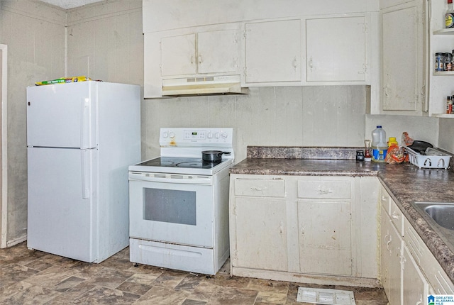 kitchen featuring white appliances and white cabinetry