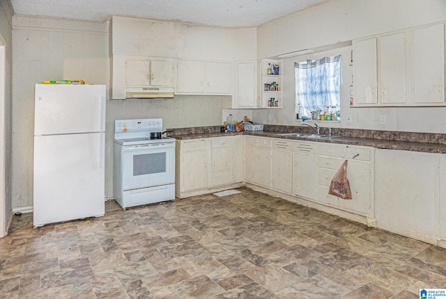 kitchen with white appliances, white cabinetry, and sink