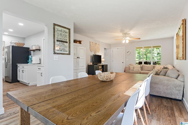 dining room with wood-type flooring and ceiling fan