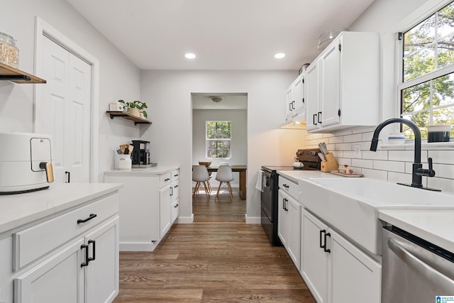 kitchen with white cabinetry, dark hardwood / wood-style floors, sink, dishwasher, and black range with electric stovetop