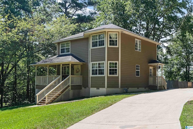 view of front of house with a front yard and covered porch