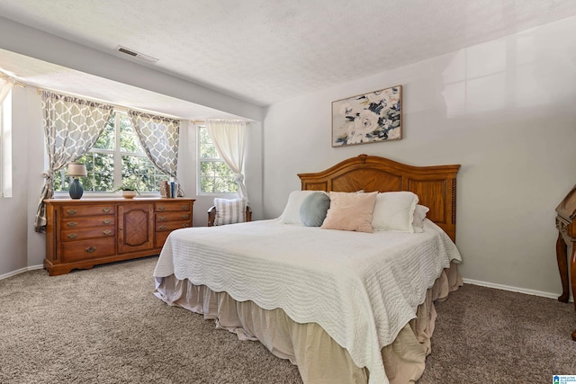 bedroom with carpet floors and a textured ceiling