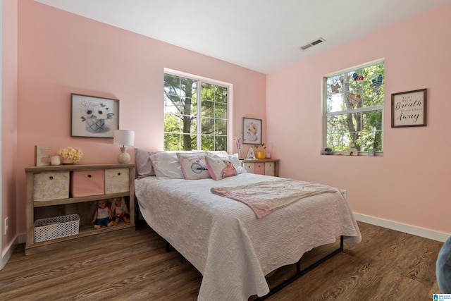 bedroom with dark wood-type flooring