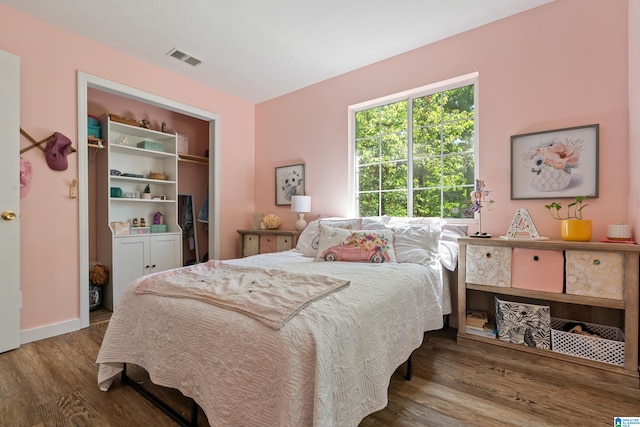 bedroom with hardwood / wood-style flooring and a closet