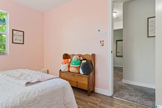 bedroom with wood-type flooring