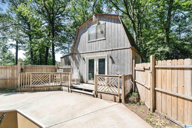 rear view of house with a deck and a patio area