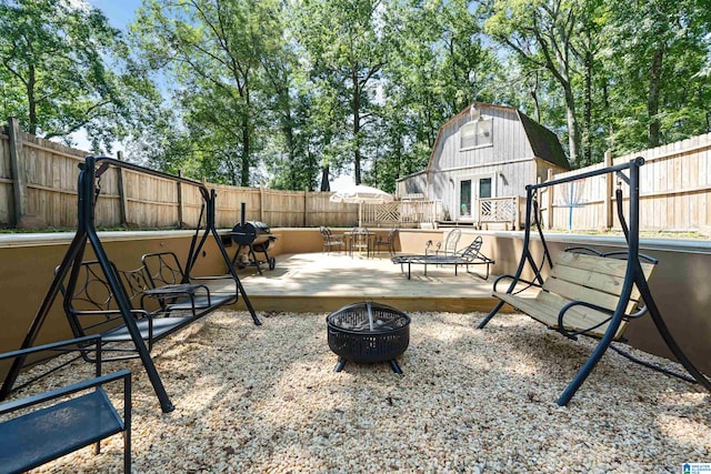 view of yard featuring an outdoor fire pit and a deck