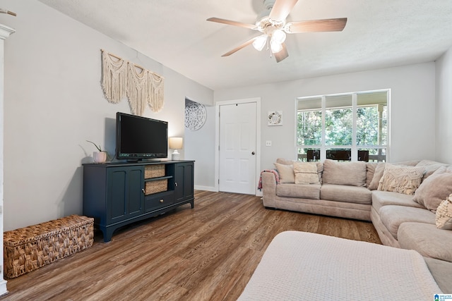 living room with hardwood / wood-style flooring and ceiling fan