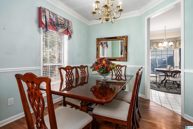 dining room featuring a chandelier, hardwood / wood-style flooring, and ornamental molding