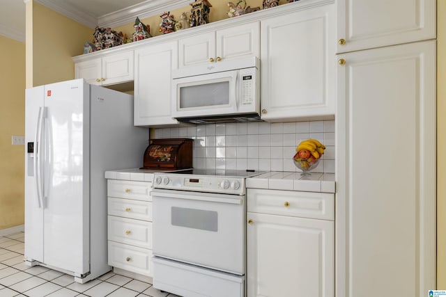 kitchen featuring ornamental molding, light tile patterned floors, white appliances, white cabinets, and decorative backsplash