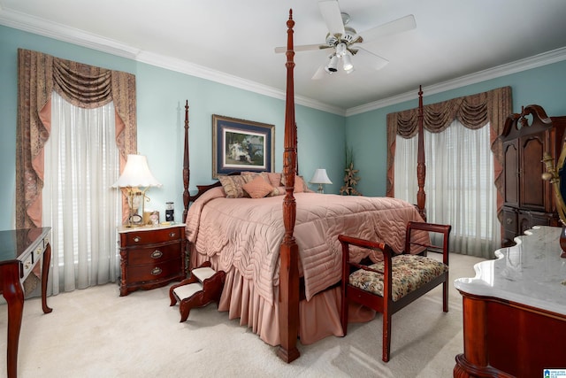 carpeted bedroom featuring ceiling fan and ornamental molding