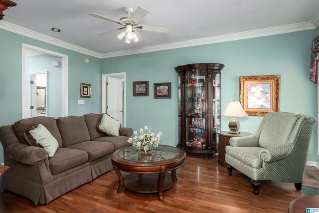 living room with ornamental molding, ceiling fan, and dark hardwood / wood-style floors