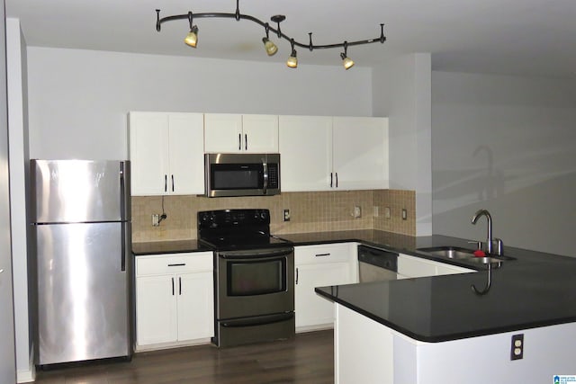 kitchen featuring tasteful backsplash, white cabinetry, appliances with stainless steel finishes, sink, and dark wood-type flooring