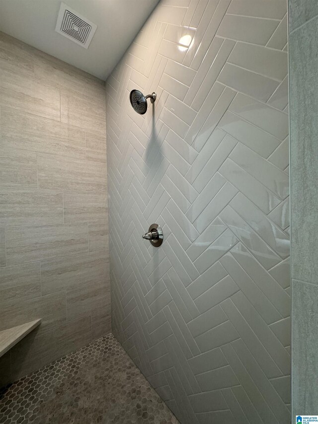 bathroom with tiled shower