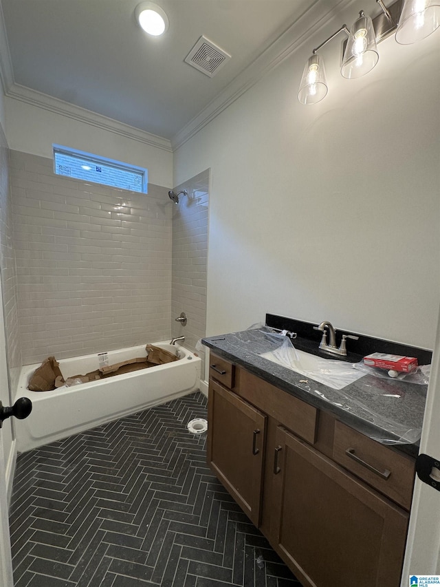 bathroom featuring vanity, ornamental molding, and tiled shower / bath