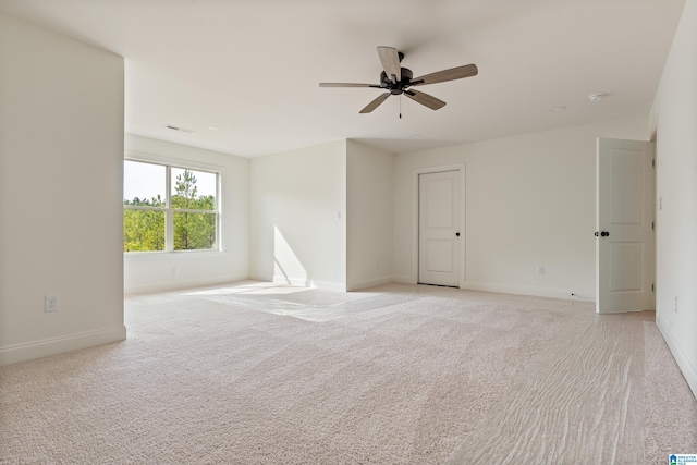 empty room featuring light carpet and ceiling fan