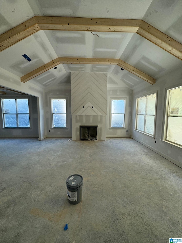 unfurnished living room featuring vaulted ceiling