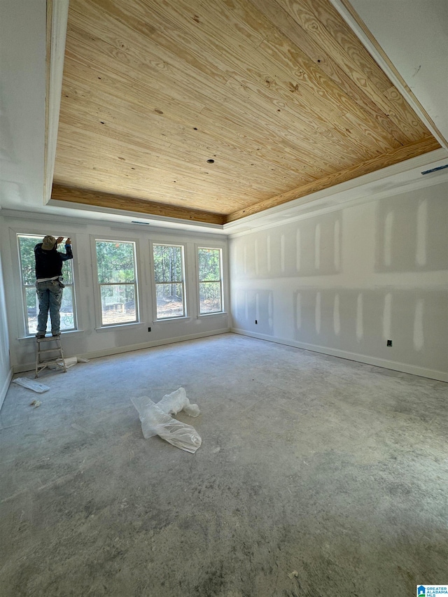 interior space featuring a tray ceiling, wood ceiling, and plenty of natural light