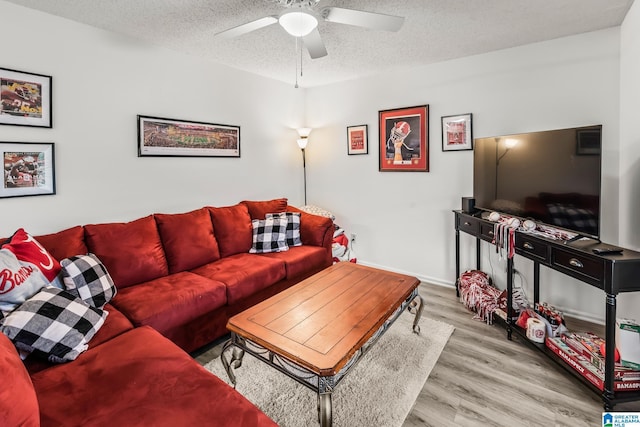 living room featuring hardwood / wood-style floors, a textured ceiling, and ceiling fan