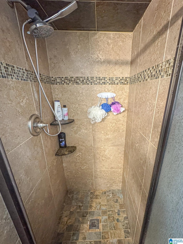 bathroom with tiled shower