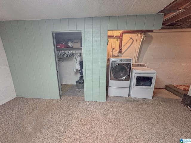 laundry area featuring washer and clothes dryer and light colored carpet