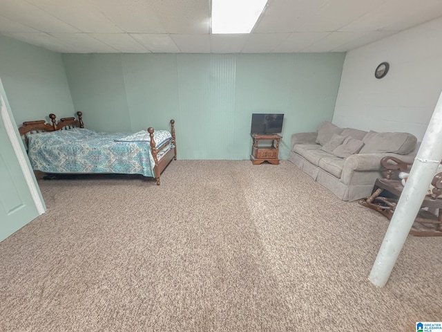 carpeted bedroom with a drop ceiling