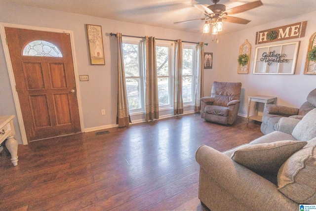 living room with ceiling fan and dark hardwood / wood-style flooring