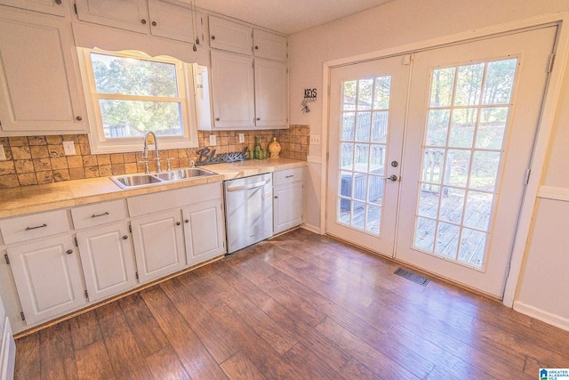 kitchen with dark hardwood / wood-style flooring, sink, stainless steel dishwasher, and french doors