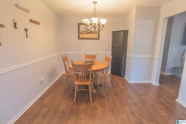 dining room with a notable chandelier and dark wood-type flooring