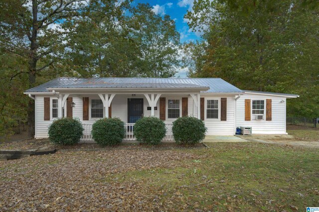 single story home with cooling unit and covered porch