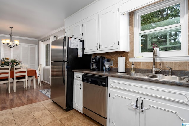 kitchen featuring sink, appliances with stainless steel finishes, light hardwood / wood-style flooring, crown molding, and white cabinets